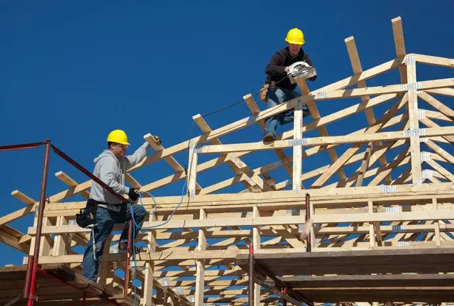 Construction crew framing a post-frame building.